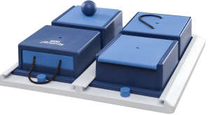 Blue-hued dog food puzzle - four boxes with lids on a larger tray